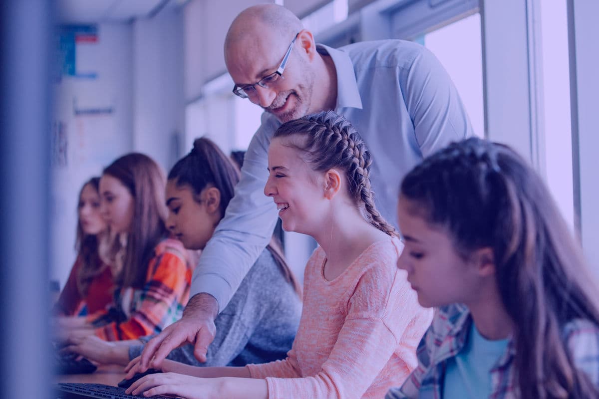 Tutor supporting a student during a computer class at Halo Tuition